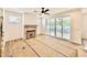 Light filled living room featuring a stone fireplace, ceiling fan, and sliding glass doors leading to the outside deck at 2621 Silver Gate Ct, Wake Forest, NC 27587