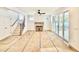 Bright living room featuring a stone fireplace, ceiling fan, and sliding glass doors leading to the outside deck at 2621 Silver Gate Ct, Wake Forest, NC 27587