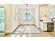 Mudroom area with built-in storage, featuring a desk and cubbies, and views of the living area at 2621 Silver Gate Ct, Wake Forest, NC 27587