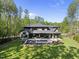 Aerial view of home showcasing the large yard, pool area, and wooded surroundings at 7640 Falls Creek Ln, Raleigh, NC 27614