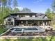 Beautiful backyard oasis with a sparkling pool, lounge area, and lush landscaping at 7640 Falls Creek Ln, Raleigh, NC 27614
