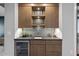 Modern wet bar with sleek cabinetry and a wine cooler at 7640 Falls Creek Ln, Raleigh, NC 27614