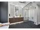 Bathroom with double vanity, freestanding tub, and glass shower at 7640 Falls Creek Ln, Raleigh, NC 27614