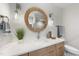 Elegant bathroom with a round mirror and a single vanity at 7640 Falls Creek Ln, Raleigh, NC 27614