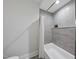 Clean bathroom with a bathtub and gray tile at 7640 Falls Creek Ln, Raleigh, NC 27614