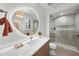 Bathroom with a round mirror, walk-in shower and modern vanity at 7640 Falls Creek Ln, Raleigh, NC 27614