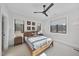 Cozy bedroom with a full bed and wood framed windows at 7640 Falls Creek Ln, Raleigh, NC 27614