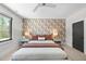 Spacious bedroom with a queen bed and patterned wall at 7640 Falls Creek Ln, Raleigh, NC 27614