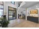 Bright entryway with hardwood floors, modern staircase, and wet bar at 7640 Falls Creek Ln, Raleigh, NC 27614