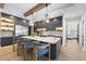 Modern kitchen with a large island, stainless steel appliances, and stylish lighting at 7640 Falls Creek Ln, Raleigh, NC 27614