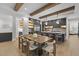 Modern kitchen with a large wooden dining table and dark gray cabinetry at 7640 Falls Creek Ln, Raleigh, NC 27614