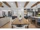 Elegant kitchen featuring a long wooden dining table and contemporary gray cabinets at 7640 Falls Creek Ln, Raleigh, NC 27614