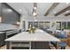 Modern kitchen island with white countertop and blue barstools, open to backyard at 7640 Falls Creek Ln, Raleigh, NC 27614