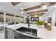 Well-appointed kitchen with a large island, modern sink, and views into the Gathering room beyond at 7640 Falls Creek Ln, Raleigh, NC 27614