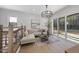 Light-filled living room with large windows and comfortable seating area at 7640 Falls Creek Ln, Raleigh, NC 27614
