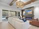 Spacious living room boasts a large sectional sofa, fireplace, and sliding glass doors at 7640 Falls Creek Ln, Raleigh, NC 27614
