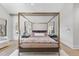 Luxury main bedroom with a canopy bed and hardwood floors at 7640 Falls Creek Ln, Raleigh, NC 27614