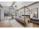 Main bedroom with a canopy bed, sitting area, and wood floors at 7640 Falls Creek Ln, Raleigh, NC 27614