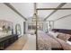 Spacious main bedroom with a four-poster bed and large windows at 7640 Falls Creek Ln, Raleigh, NC 27614