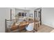 Home office with built-in desk, light-filled sitting area, and wood flooring at 7640 Falls Creek Ln, Raleigh, NC 27614