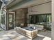 Inviting outdoor living area featuring a cozy fireplace and comfortable seating, perfect for relaxation and entertainment at 7640 Falls Creek Ln, Raleigh, NC 27614