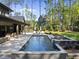 Stunning pool and spa offer a luxurious outdoor retreat, complemented by a covered patio and lush landscaping at 7640 Falls Creek Ln, Raleigh, NC 27614