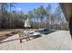Luxury pool with spa and lounge chairs, surrounded by trees at 7640 Falls Creek Ln, Raleigh, NC 27614