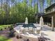Relaxing pool area with lounge chairs and umbrellas surrounded by lush greenery creates a private backyard oasis at 7640 Falls Creek Ln, Raleigh, NC 27614