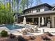 Inviting backyard features a sparkling pool, spa, lounge chairs, and an outdoor dining area, perfect for relaxation at 7640 Falls Creek Ln, Raleigh, NC 27614