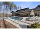 Luxury pool and spa with spacious patio and lounge chairs at 7640 Falls Creek Ln, Raleigh, NC 27614