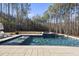 Inviting swimming pool with a spa and a wooded backdrop at 7640 Falls Creek Ln, Raleigh, NC 27614