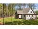 Side and back view of home surrounded by manicured lawn and mature trees at 330 Hidden Lake Dr, Youngsville, NC 27596