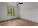 Bright bedroom featuring hardwood floors, a ceiling fan, and a window with a view of the trees at 330 Hidden Lake Dr, Youngsville, NC 27596