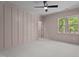 Bright bedroom featuring carpet, gray walls, and a window with a view of the trees at 330 Hidden Lake Dr, Youngsville, NC 27596