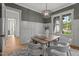 Dining room boasts stylish light fixture, wainscoting, and a view of the outdoors at 330 Hidden Lake Dr, Youngsville, NC 27596