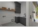Laundry room with gray cabinetry, counter space, shelving, sink and modern faucet at 330 Hidden Lake Dr, Youngsville, NC 27596