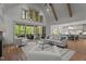 Spacious living room with high ceilings, wood beams, and sliding doors to outdoor screened deck at 330 Hidden Lake Dr, Youngsville, NC 27596