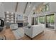 Open living room featuring high ceilings, fireplace, built-in shelving, and sliding doors to deck at 330 Hidden Lake Dr, Youngsville, NC 27596