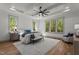 Elegant main bedroom with tray ceiling, ceiling fan and large windows with wooded view at 330 Hidden Lake Dr, Youngsville, NC 27596