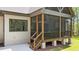 Elevated screened porch with stairs leading to the yard at 330 Hidden Lake Dr, Youngsville, NC 27596