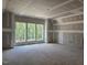 Large, unfinished living room area featuring drywall and many large windows for natural light at 3340 Colby Chase Dr # 2, Apex, NC 27539
