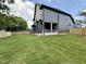 Expansive backyard with a covered patio and a lush green lawn, ideal for outdoor living at 627 Georgetown Rd, Raleigh, NC 27608