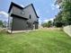 Large, grassy backyard featuring a newly constructed home, complemented by a wooden fence at 627 Georgetown Rd, Raleigh, NC 27608