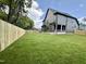 Extensive backyard with green lawn and wooden fence bordering a modern home, offering privacy at 627 Georgetown Rd, Raleigh, NC 27608
