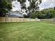 Spacious backyard featuring a well-maintained lawn and a new wooden fence for privacy at 627 Georgetown Rd, Raleigh, NC 27608