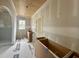 Bathroom featuring shiplap ceiling and tiled shower awaiting the finishing touches at 627 Georgetown Rd, Raleigh, NC 27608