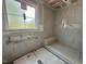 Bright bathroom with white tiled shower featuring bench and niche at 627 Georgetown Rd, Raleigh, NC 27608