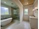 Bright bathroom with tiled floor, stand alone tub, glass shower, and wooden ceiling at 627 Georgetown Rd, Raleigh, NC 27608