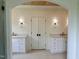 Bathroom features dual vanities with stone countertops, decorative lighting, and wood paneled ceiling at 627 Georgetown Rd, Raleigh, NC 27608