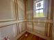 Bathroom with white wainscoting, wood trim, and a window at 627 Georgetown Rd, Raleigh, NC 27608